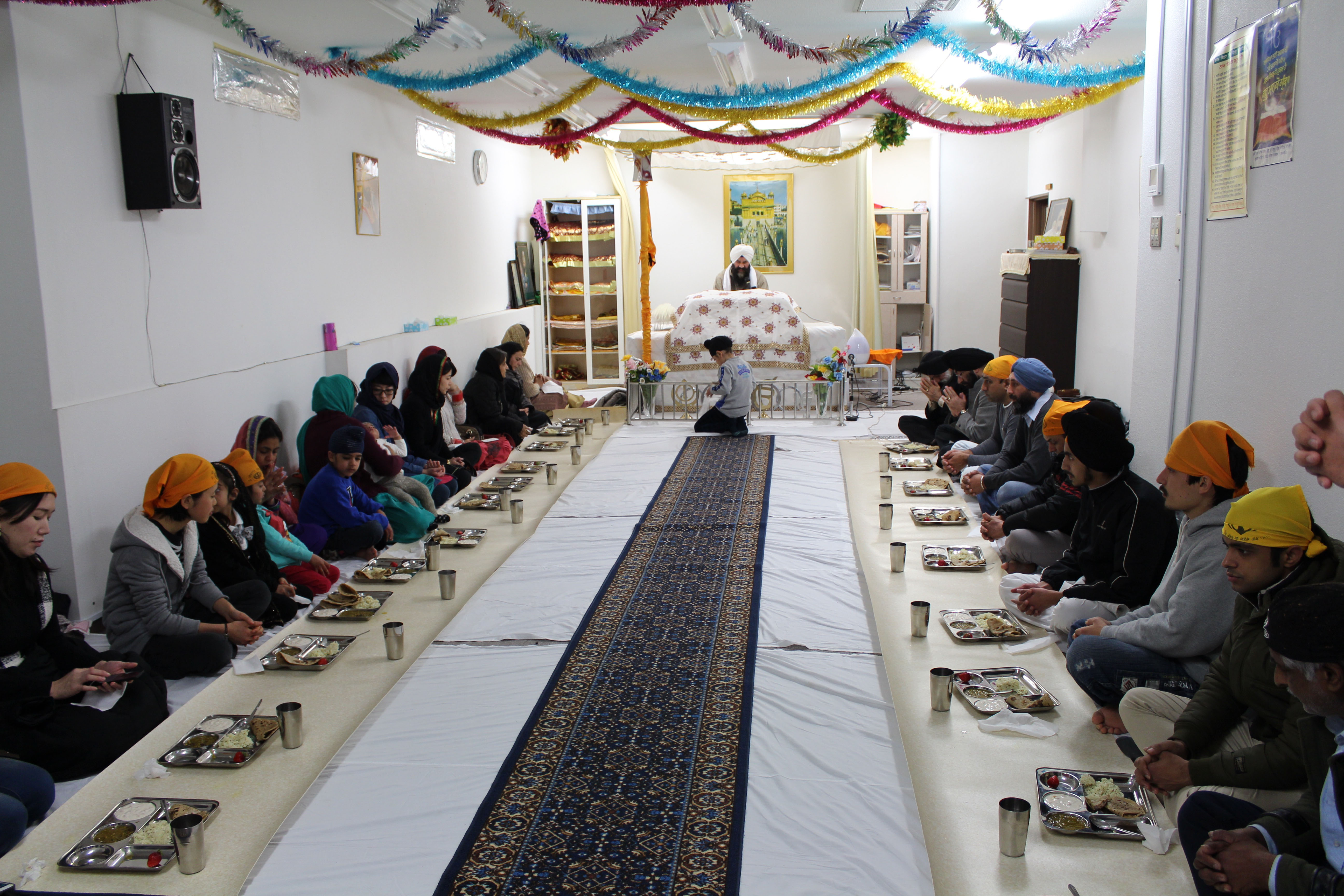 Group meals like this one at the Tokyo gurdwara, served for free to all attendees no matter their faith, are an important feature of Sikhism. | MEGHA WADHWA