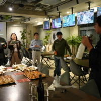Kengo Suzuki, president of Tsunan Brewery Co., Ltd. and known among friends as 'Ken'GO' Suzuki,' pours a glass of the brewery's 'GO' sake for fellow guests at GO-ya Day in Tokyo.